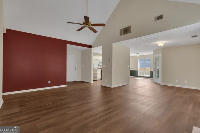 a view of an empty room with wooden floor