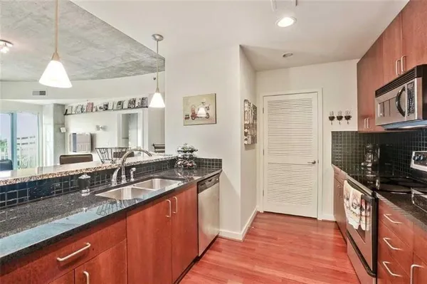 a kitchen with granite countertop a sink and a stove