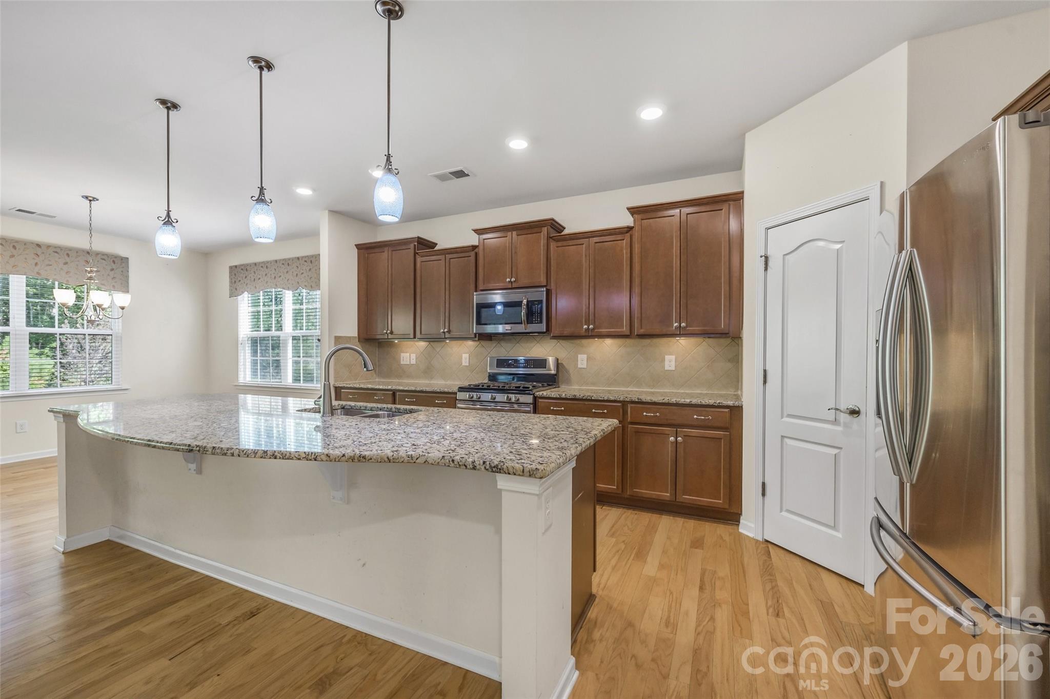 4201 Perth Road Fort Mill, SC 29707 - Photo 14 of 35 a kitchen with stainless steel appliances granite countertop a refrigerator a sink a stove and a wooden floors