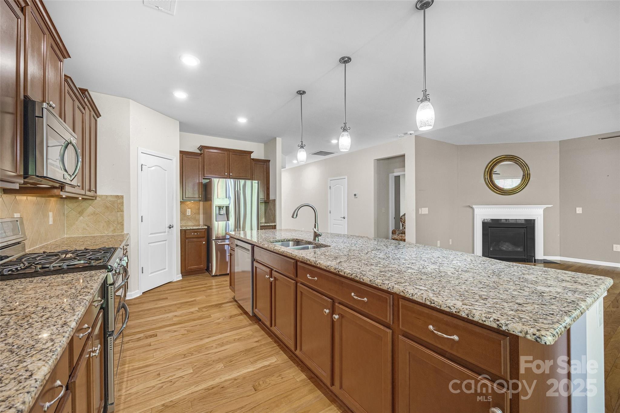 4201 Perth Road Fort Mill, SC 29707 - Photo 21 of 38 a large kitchen with granite countertop a island in the center and stainless steel appliances