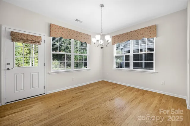 a view of an empty room with a window and balcony