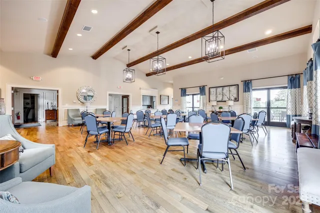 a living room with lots of furniture and wooden floors