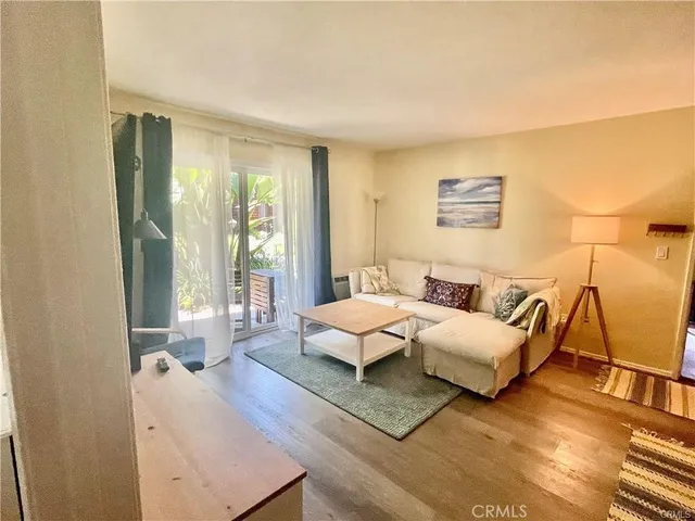 a spacious bedroom with a bed couch and a large window