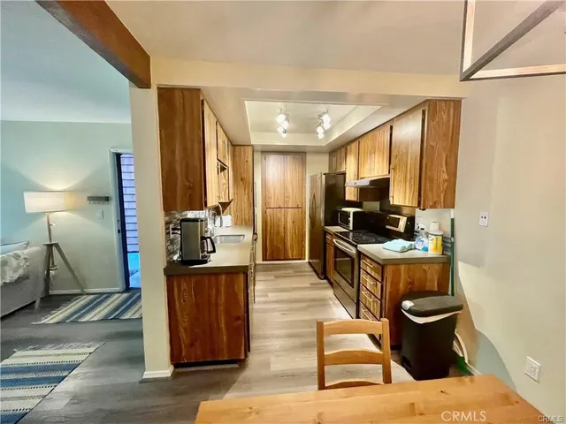 a kitchen with a refrigerator and a sink