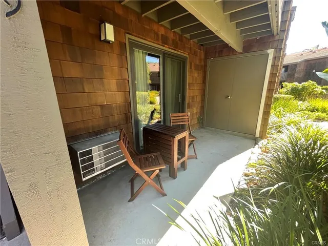 a balcony with table and chairs