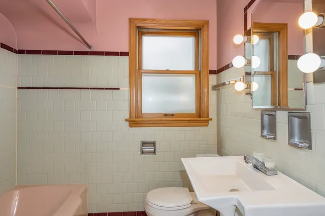 a bathroom with a sink a toilet and a mirror