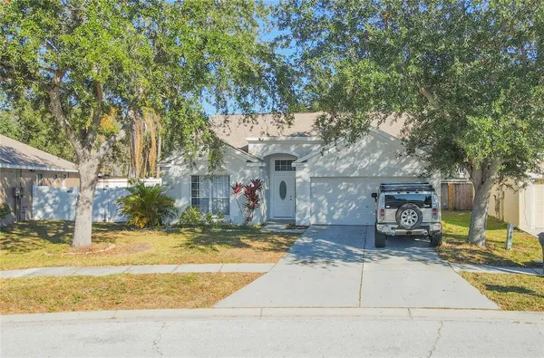 a view of a house with cars park