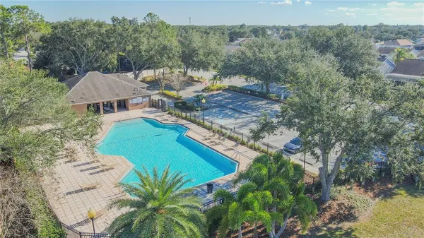 an aerial view of a house with a yard and lake view