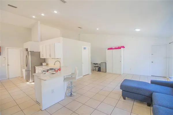 a kitchen with a refrigerator and a stove top oven