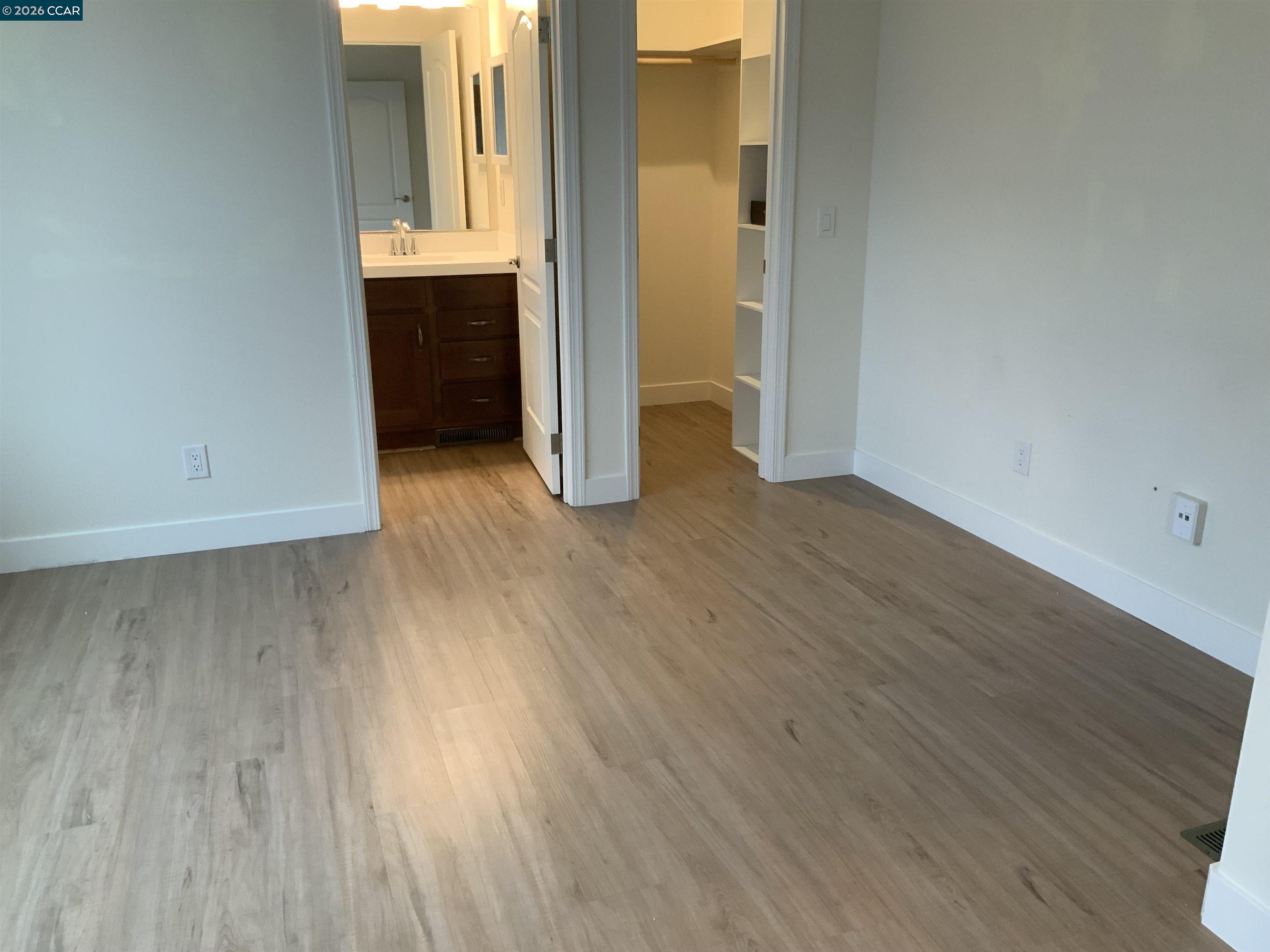 65 Pali Way Pittsburg, CA 94565 - Photo 12 of 32 an empty room with wooden floor and cabinet