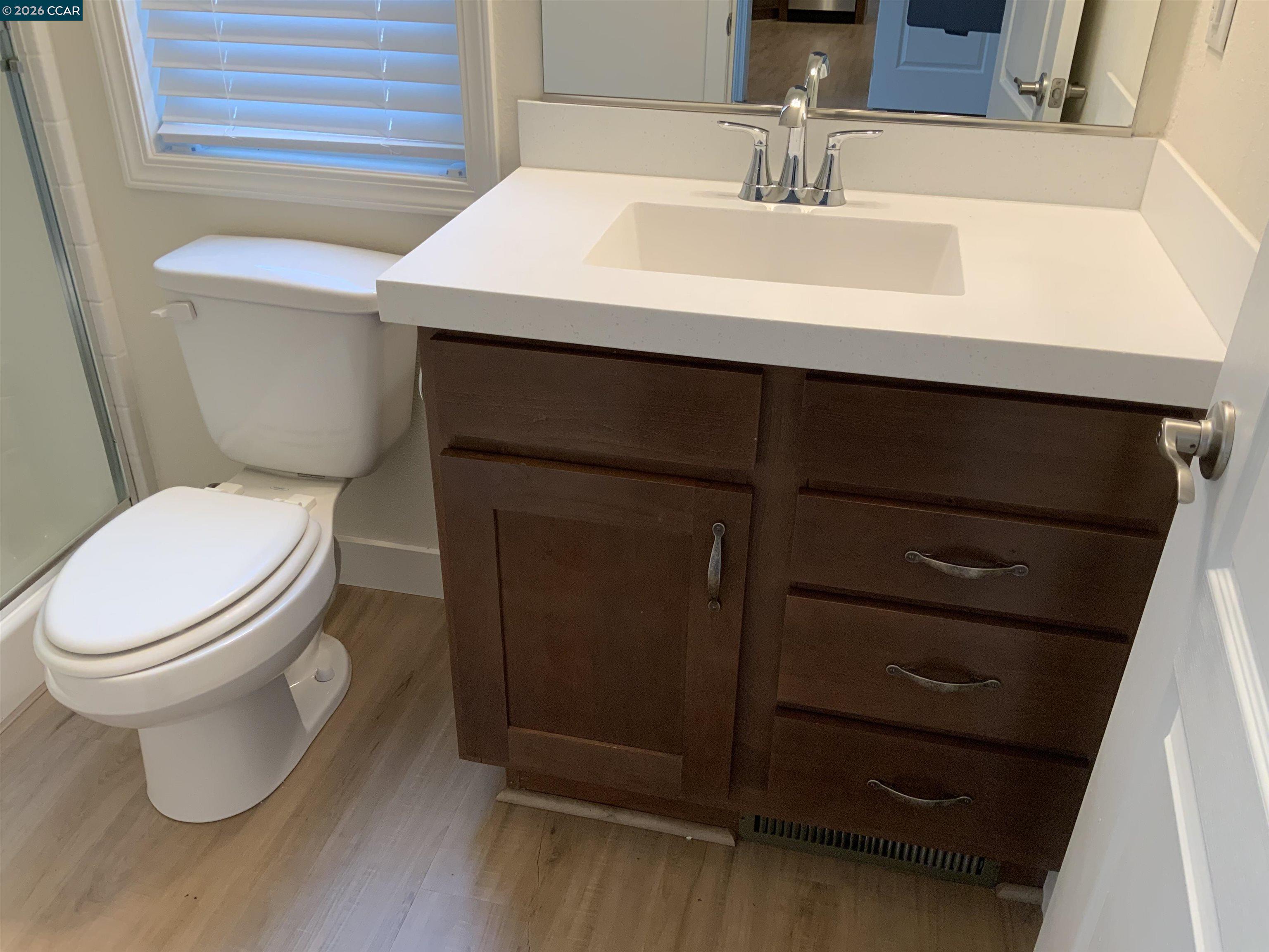 65 Pali Way Pittsburg, CA 94565 - Photo 17 of 32 a bathroom with a sink toilet and mirror
