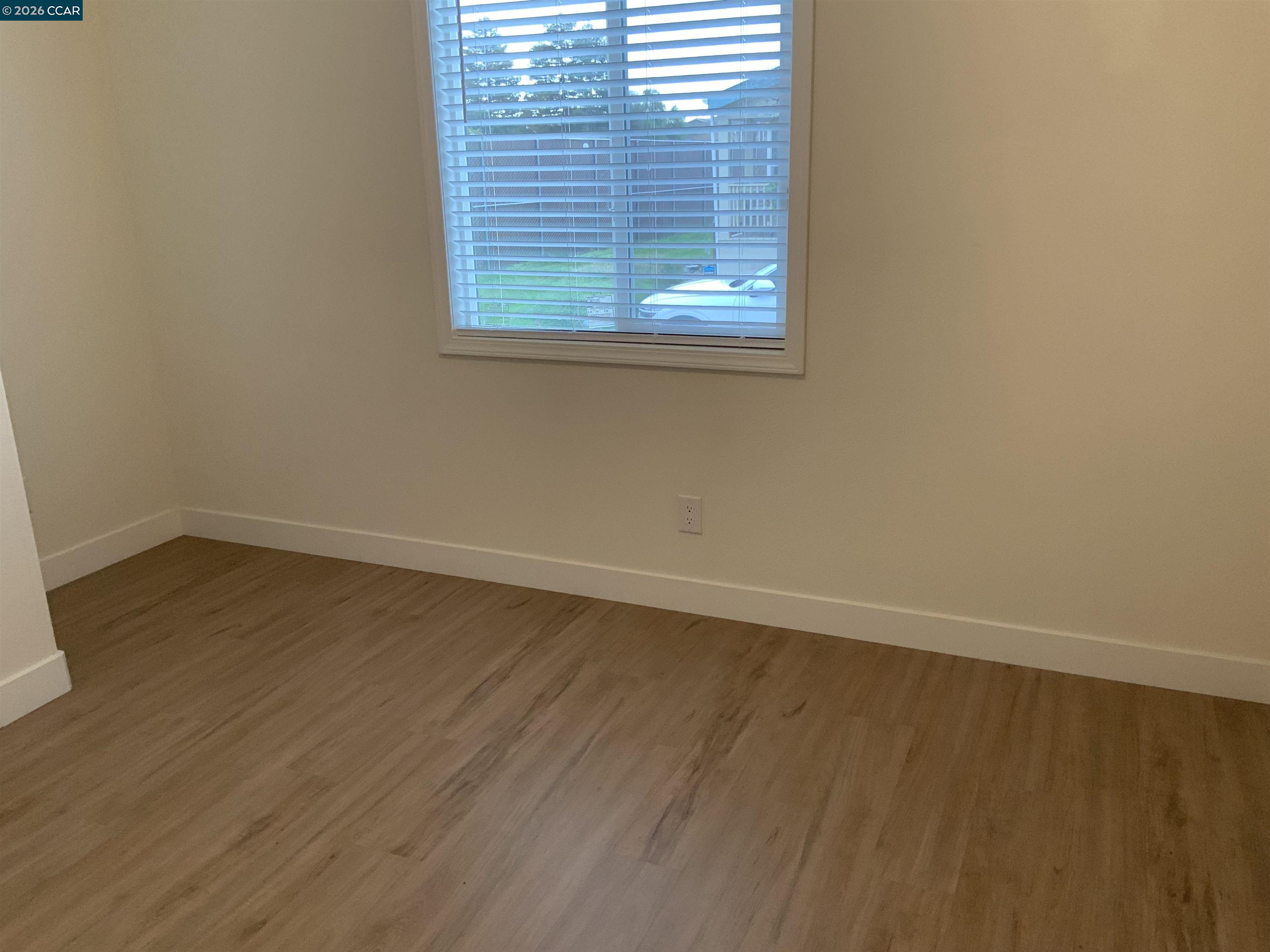 65 Pali Way Pittsburg, CA 94565 - Photo 19 of 32 an empty room with wooden floor and windows