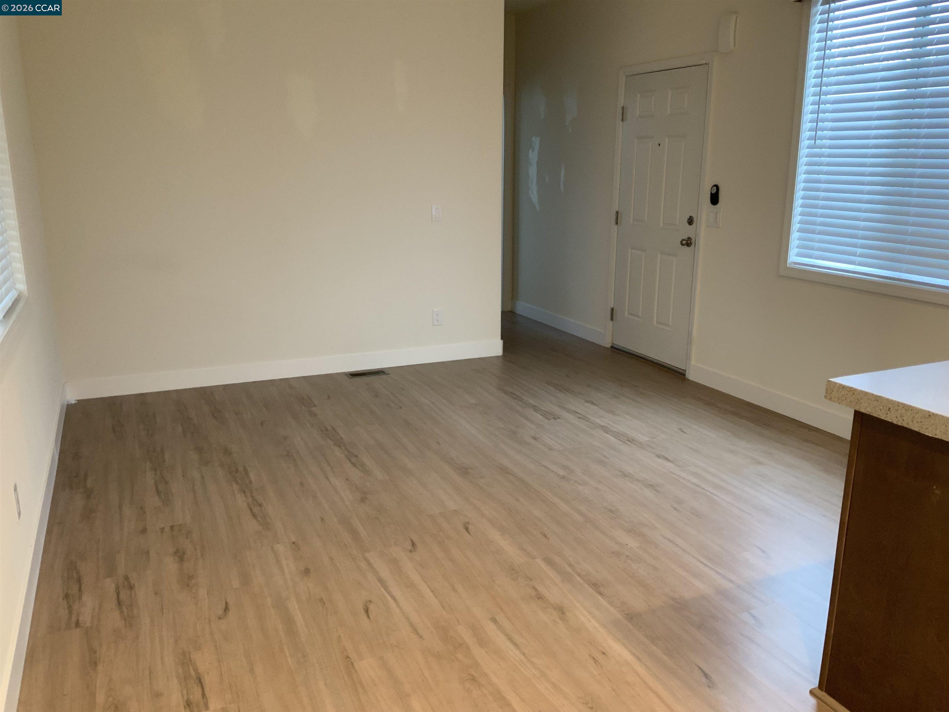 65 Pali Way Pittsburg, CA 94565 - Photo 4 of 32 a view of an empty room with wooden floor and a window