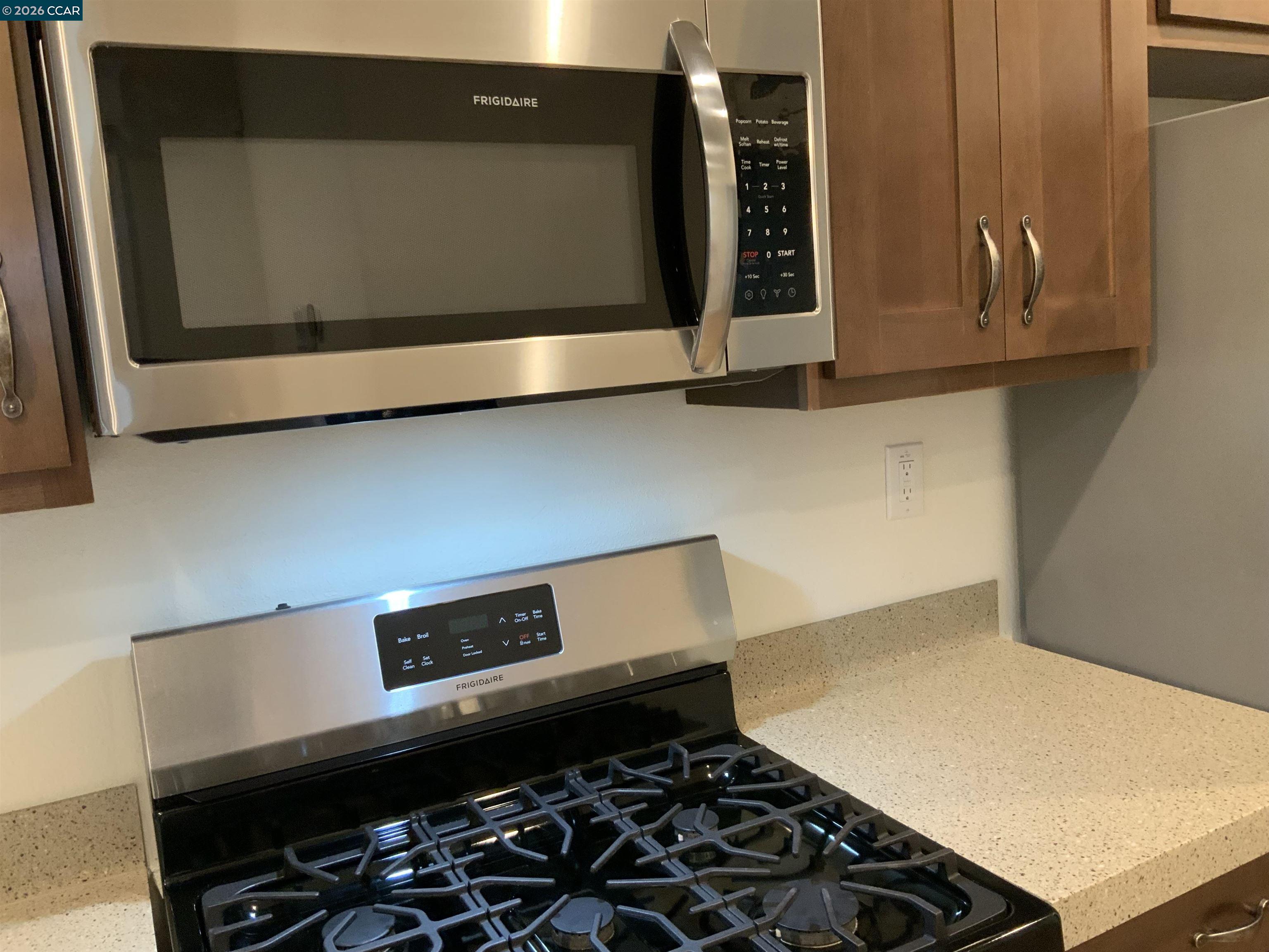 65 Pali Way Pittsburg, CA 94565 - Photo 8 of 32 a kitchen with a stove and a microwave
