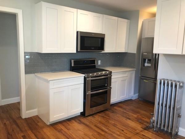 83 Dana Street Springfield, MA 01104 - Photo 11 of 20 a kitchen with a stove and a microwave