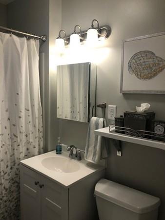 83 Dana Street Springfield, MA 01104 - Photo 12 of 20 a bathroom with a sink a toilet and mirror