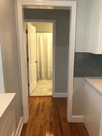 83 Dana Street Springfield, MA 01104 - Photo 15 of 20 a view of a hallway with wooden floor