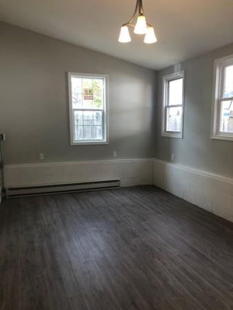 83 Dana Street Springfield, MA 01104 - Photo 17 of 20 an empty room with wooden floor and windows