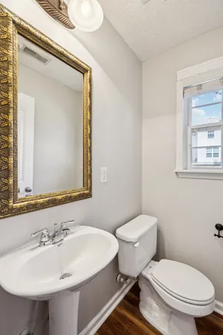 a bathroom with a sink mirror and toilet