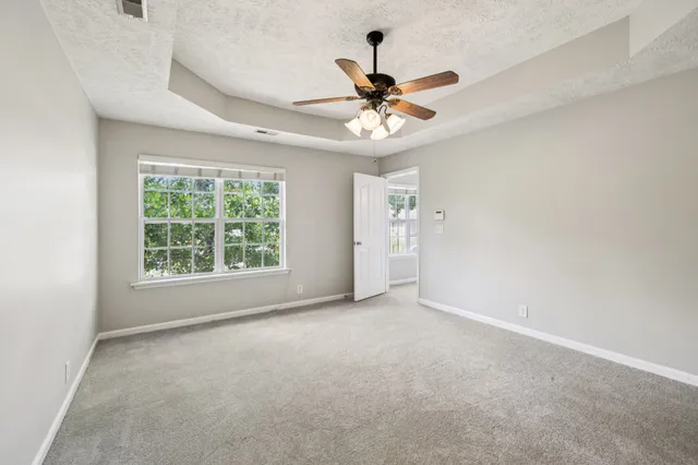 a bathroom with a granite countertop sink a toilet and a mirror