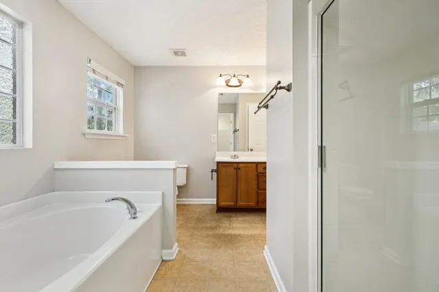 a white bath tub sitting next to a window
