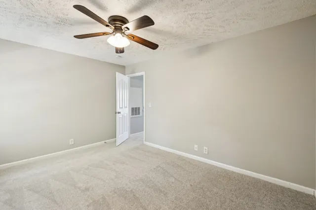 a view of a backyard with a large tree