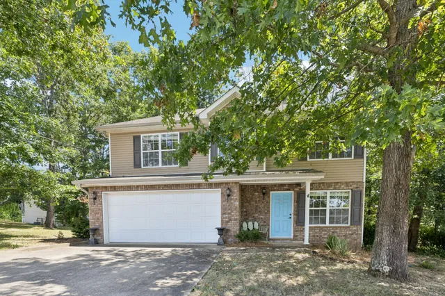 front view of a house with a tree