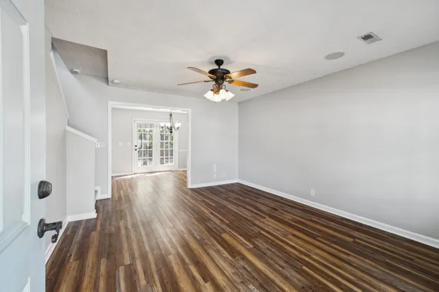 wooden floor in an empty room with a window