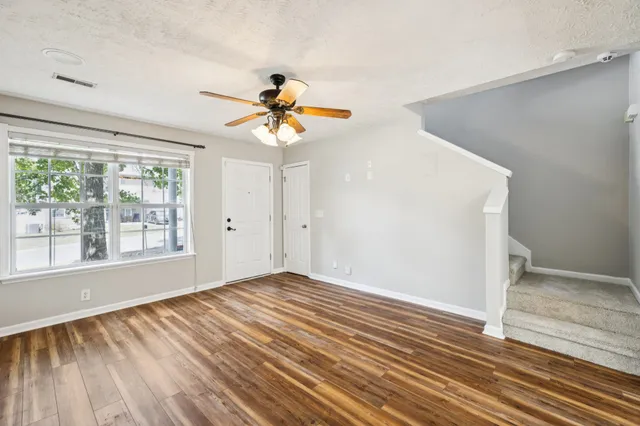 a view of a room with wooden floor and window