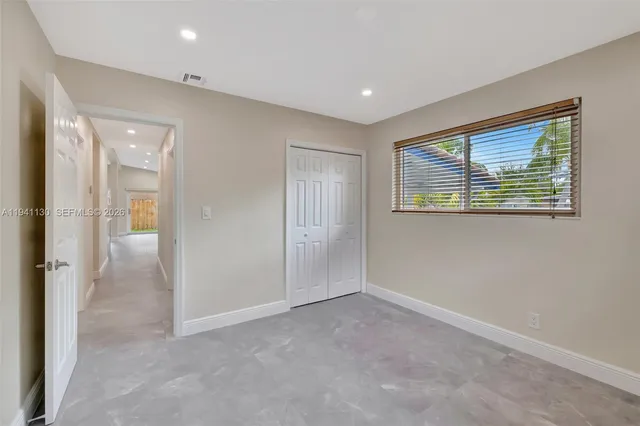 a bathroom with a granite countertop toilet a sink and a bathtub