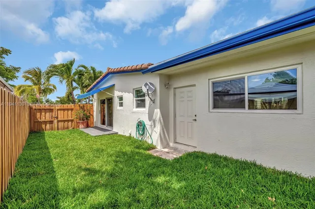 a view of a yard with a palm tree