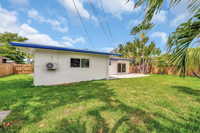 a view of a house with a backyard