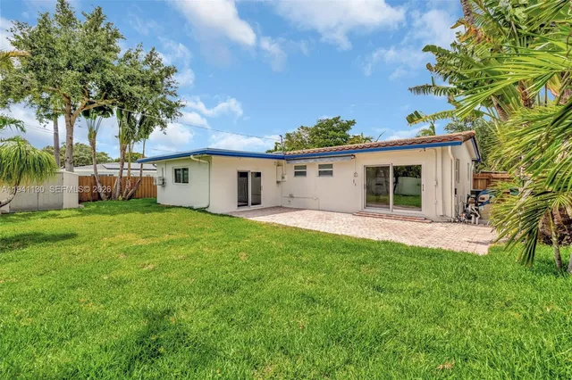 a view of a house with a yard and a garage