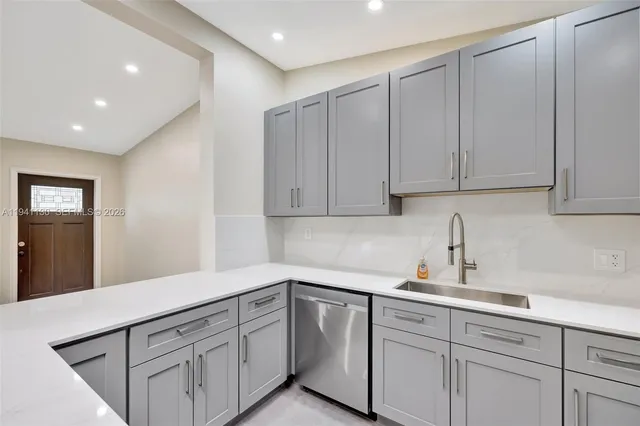 a kitchen with cabinets stainless steel appliances and a counter space