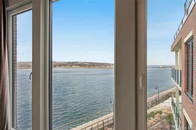 a living room kitchen with a dining table wooden floor and a view of kitchen