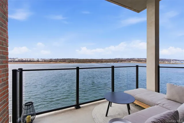 a balcony with table and chairs