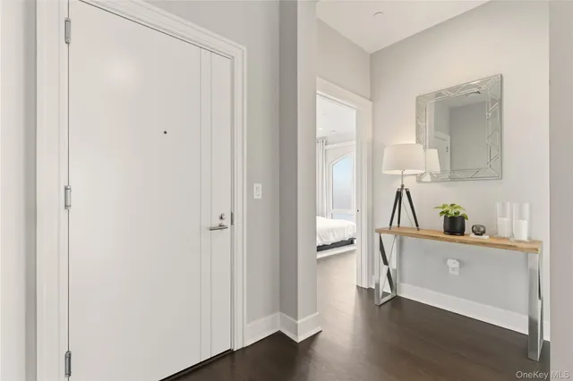 a view of a kitchen and an entryway with wooden floor