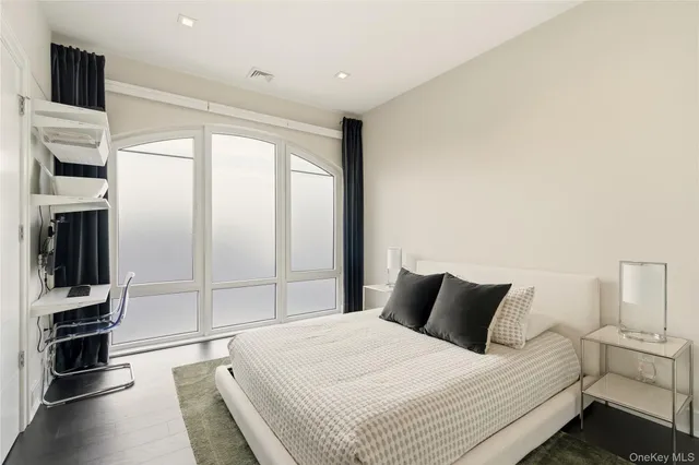 a bathroom with a toilet sink vanity and mirror