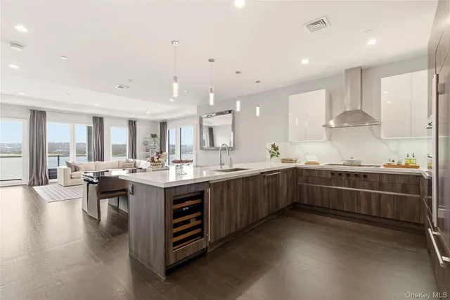 a kitchen with stainless steel appliances kitchen island granite countertop a sink and cabinets