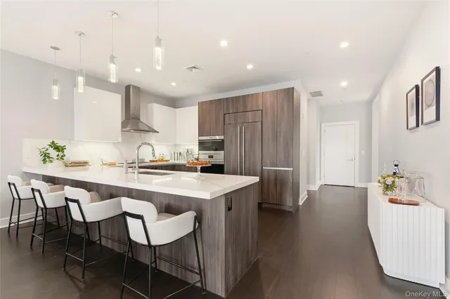 a kitchen with stainless steel appliances a sink stove and refrigerator