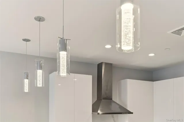 a kitchen with kitchen island a stove a table and chairs in it