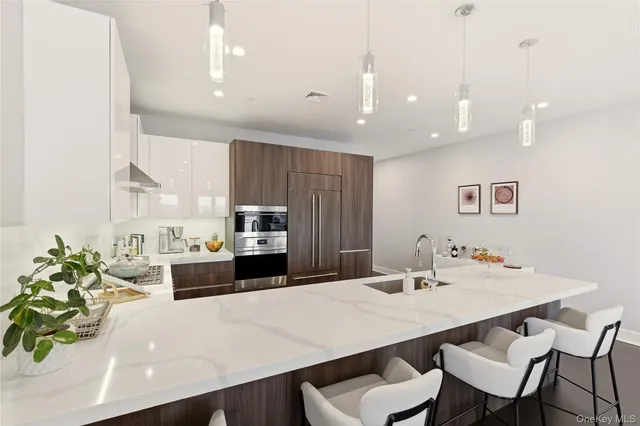 a kitchen with a dining table chairs and wooden floor