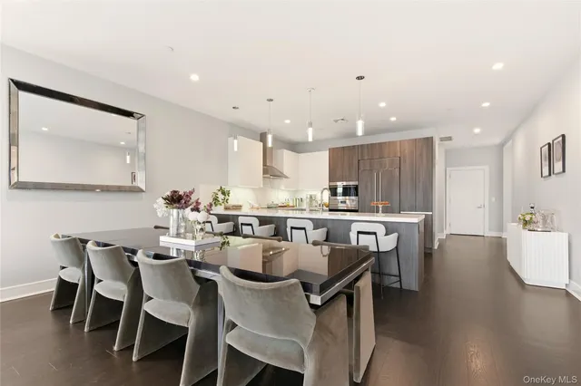 a kitchen with a table chairs stove and wooden floor