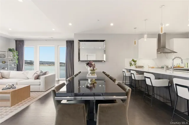 a living room with furniture large windows and a flat screen tv