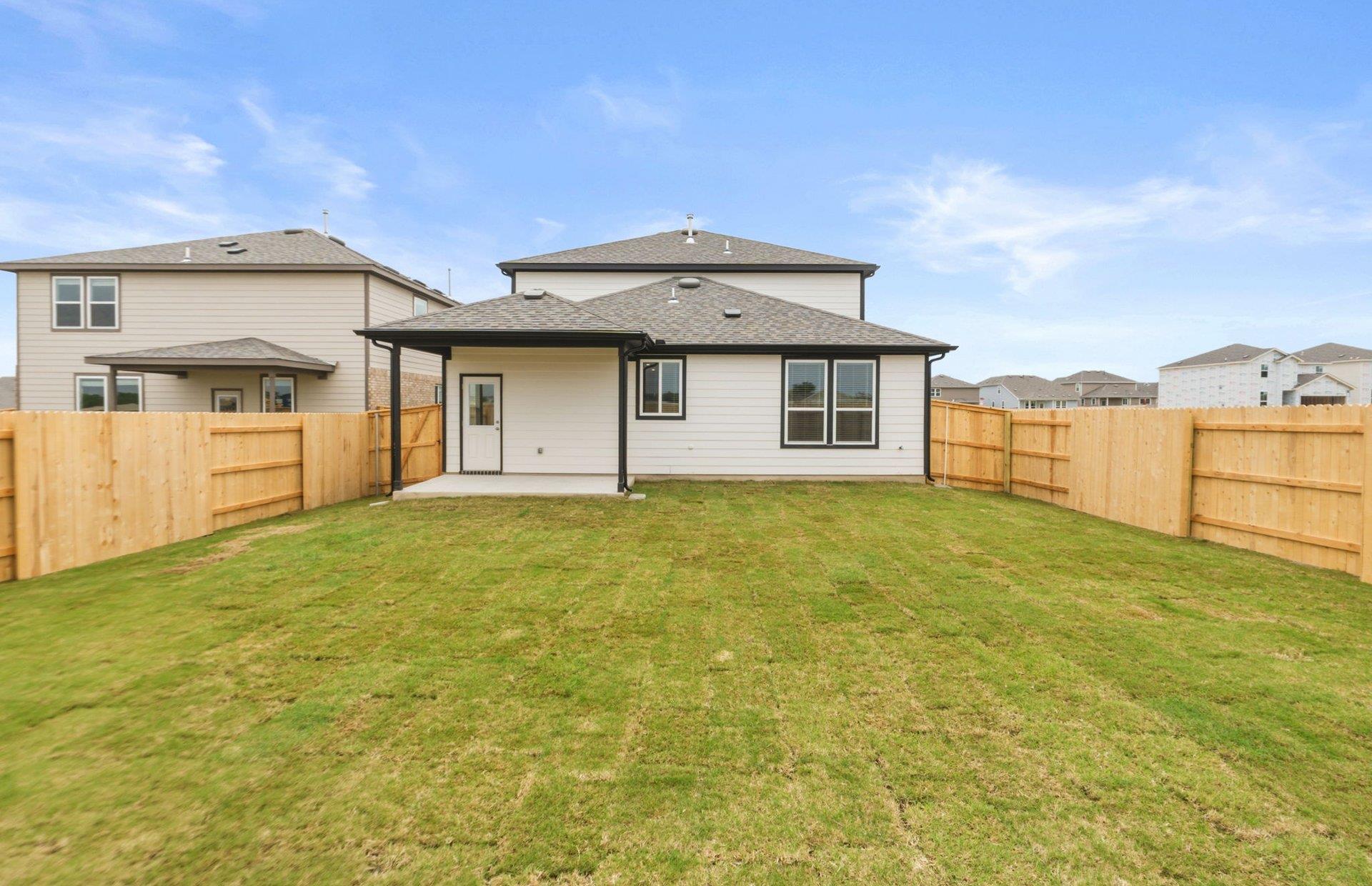 545 Henry Milton Road Georgetown, TX 78626 - Photo 20 of 33 A spacious lawn and covered patio await in this fully fenced backyard.