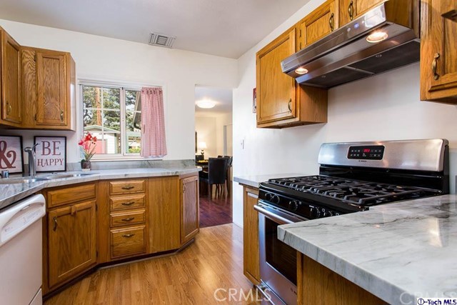 1707 Arlington Avenue Glendale, CA 91208 - Photo 14 of 39 a kitchen with stainless steel appliances granite countertop a stove a sink and a microwave
