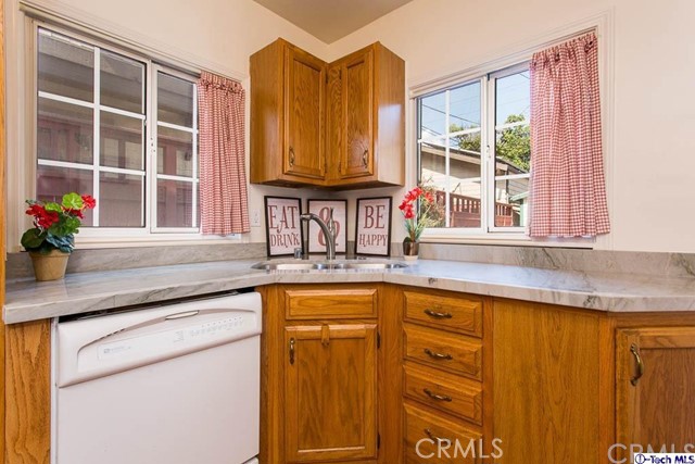 1707 Arlington Avenue Glendale, CA 91208 - Photo 15 of 39 a kitchen with granite countertop wooden cabinets and a large window