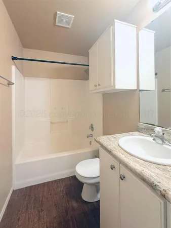 a bathroom with a sink a toilet and a bathtub