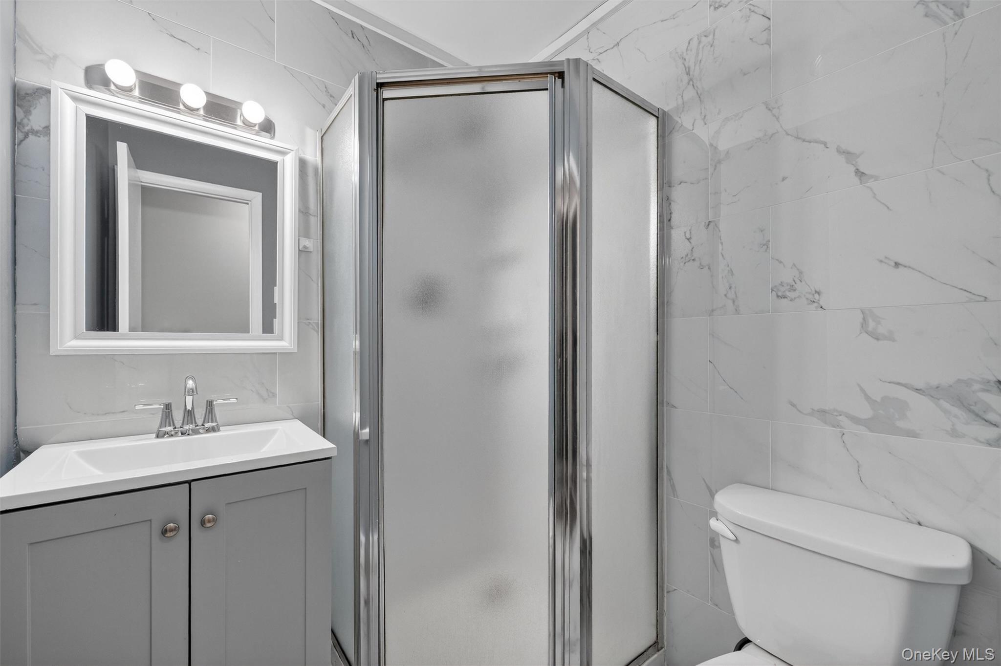 98 South Mount Airy Road Croton-on-Hudson, NY 10520 - Photo 19 of 36 a bathroom with a toilet a sink and mirror