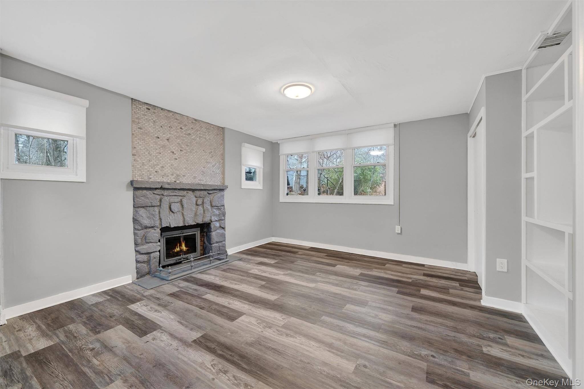 98 South Mount Airy Road Croton-on-Hudson, NY 10520 - Photo 20 of 36 a view of empty room with fireplace and wooden floor